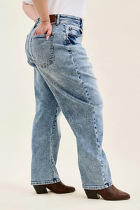 Light blue jeans worn by a person on a white background