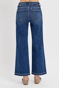 Blue jeans worn by a person on a white background