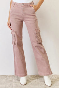 Pink cargo pants worn by a person on a plain background