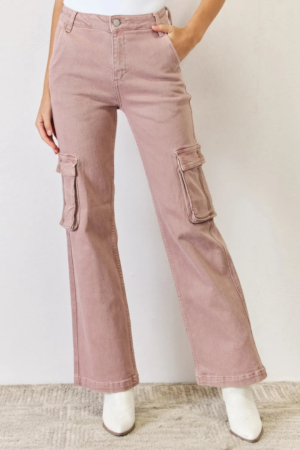 Pink cargo pants worn by a person on a plain background