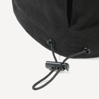 Close-up of a black cap with a chin strap on a white background