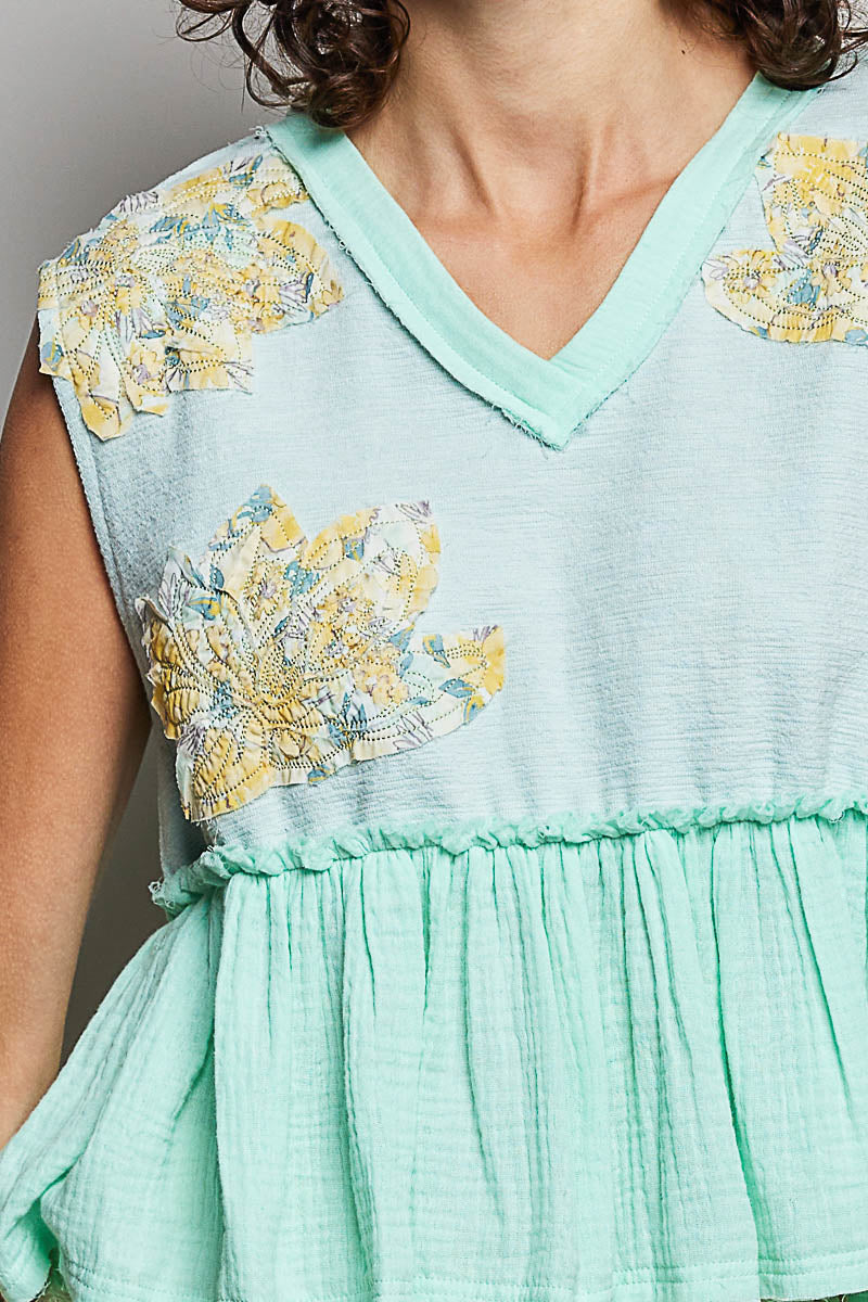 Mint green dress with floral sleeves and neckline