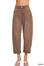 Brown jeans worn by a person on a white background