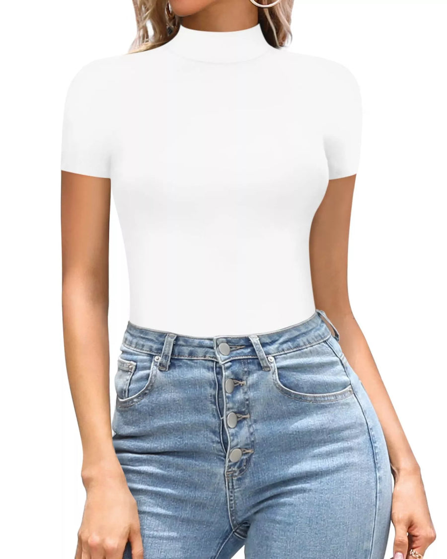 Person wearing a white turtleneck and blue jeans on a white background