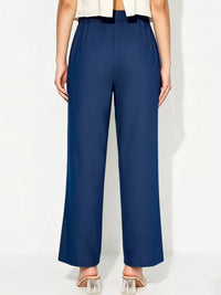 Person wearing navy blue pants on a white background
