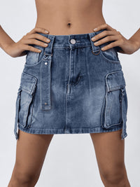 Blue denim skirt worn by a person on a white background