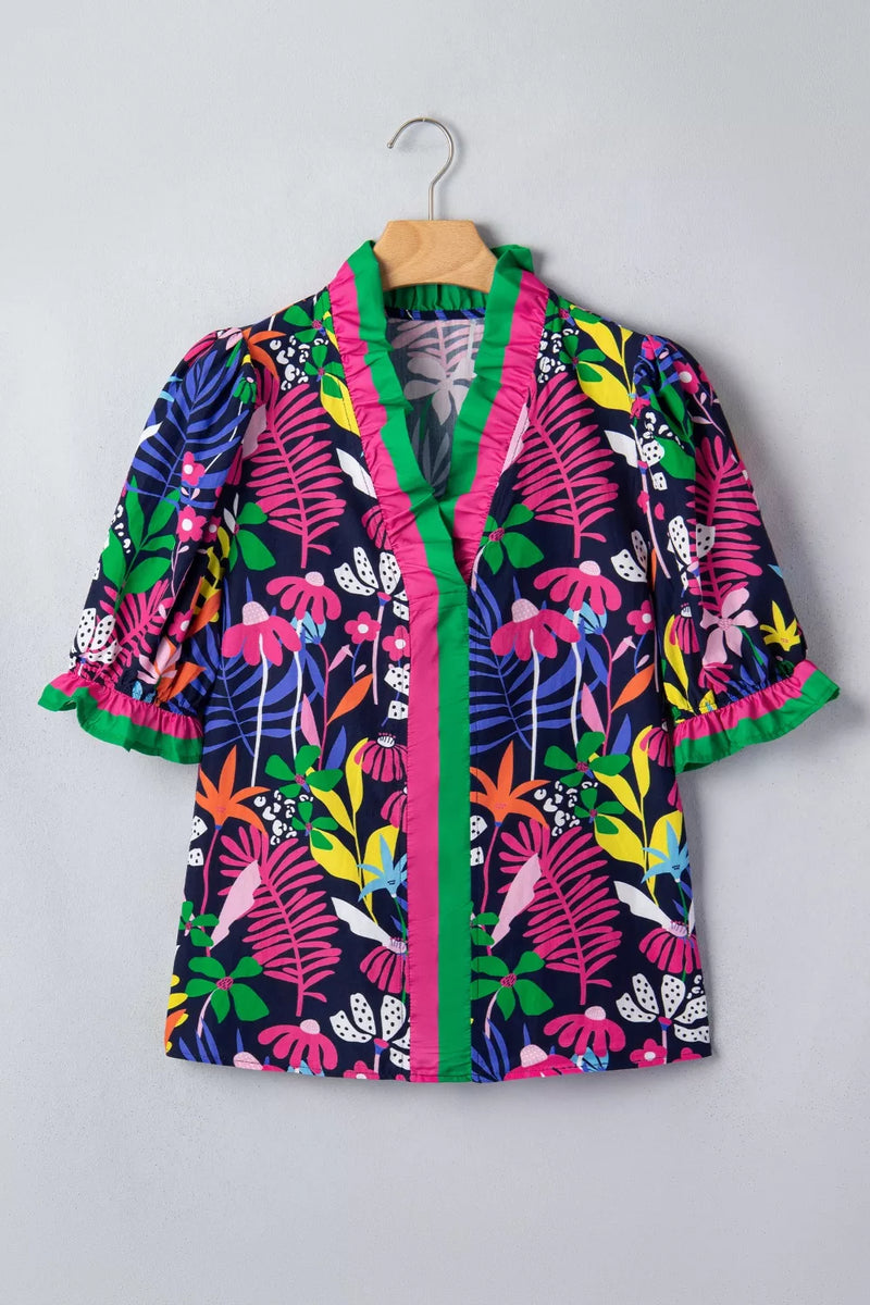 Colorful floral-patterned jacket on a hanger against a gray background