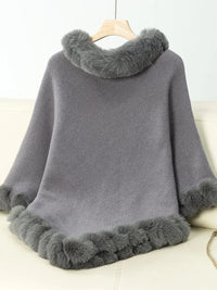 Gray poncho with fur trim on a white background