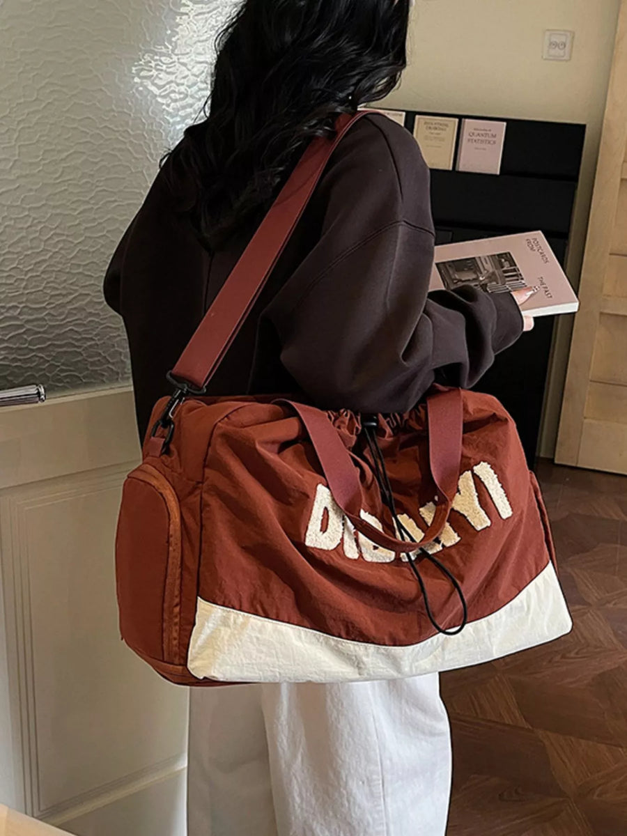 Person carrying a brown and white bag with 'DESEMI' branding in an indoor setting.