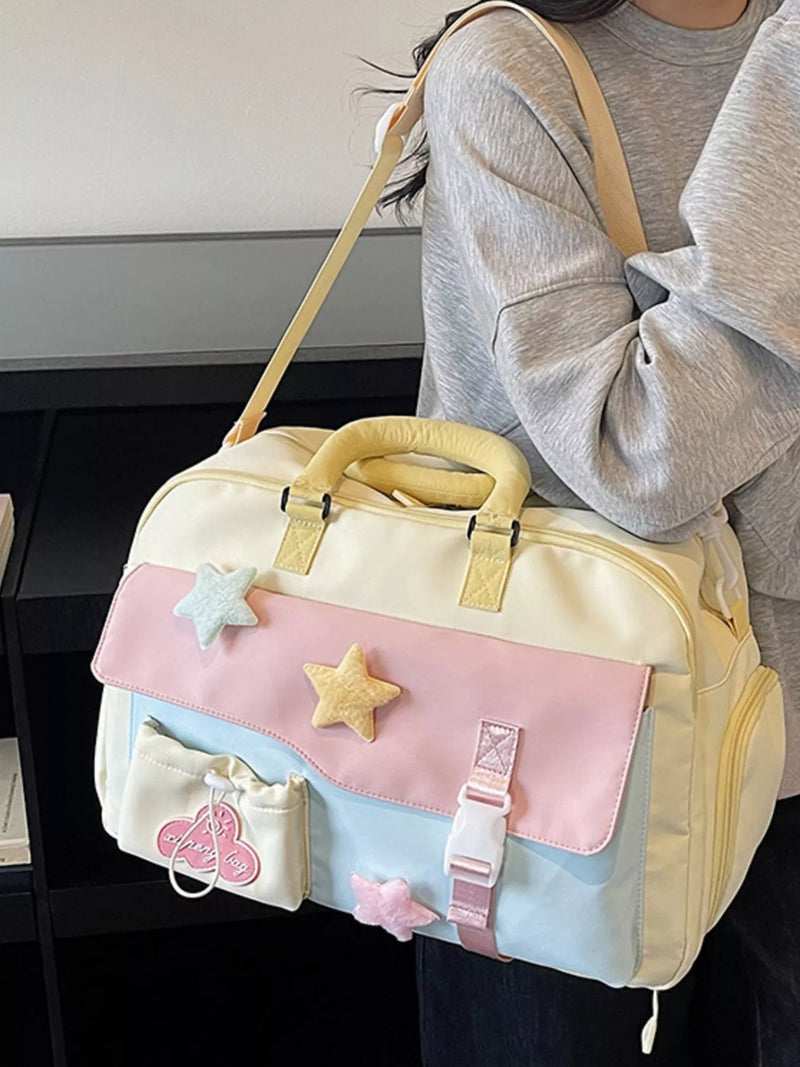 Pastel-colored bag with star decorations held by a person wearing a gray sweater.