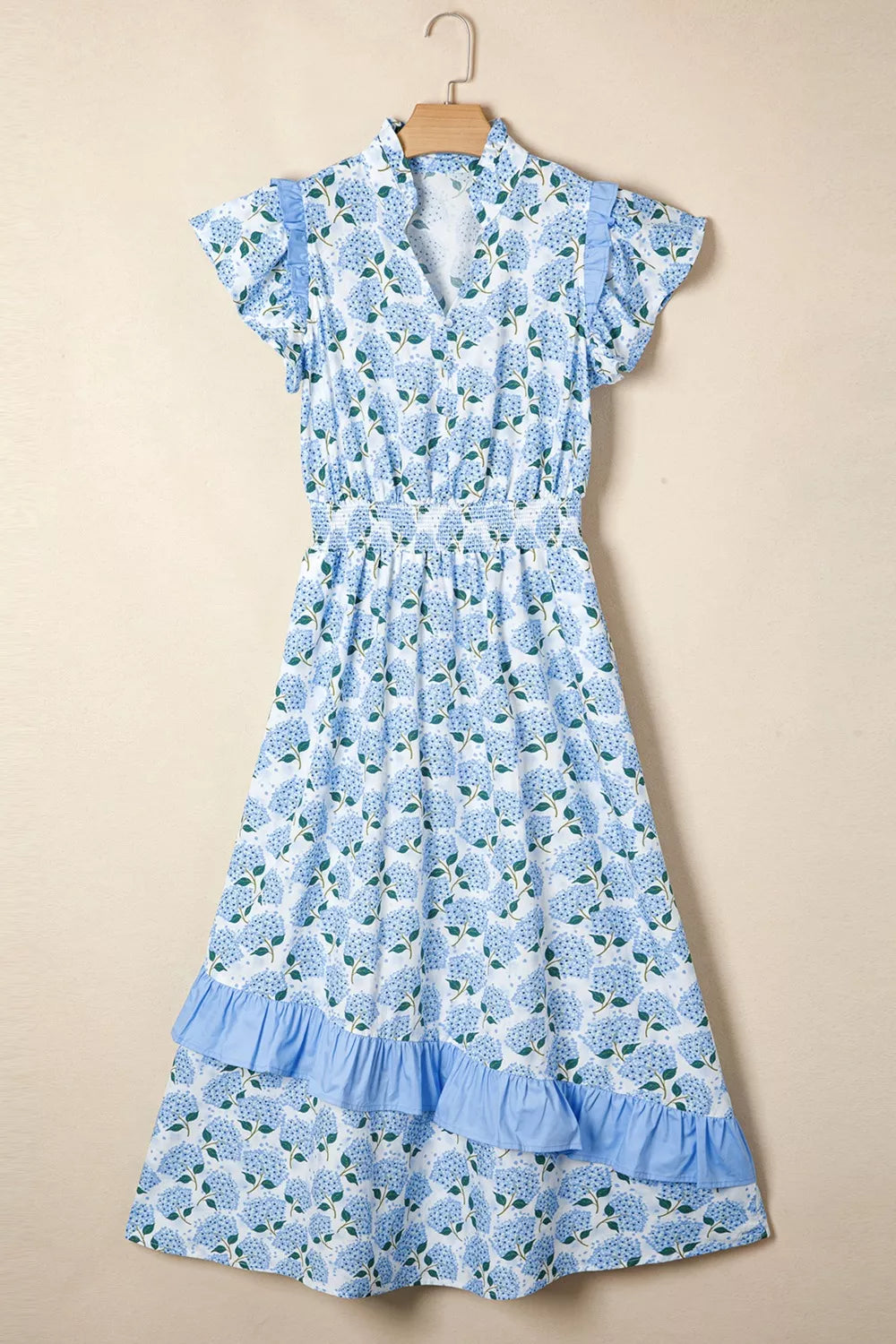 Blue floral dress on a beige background