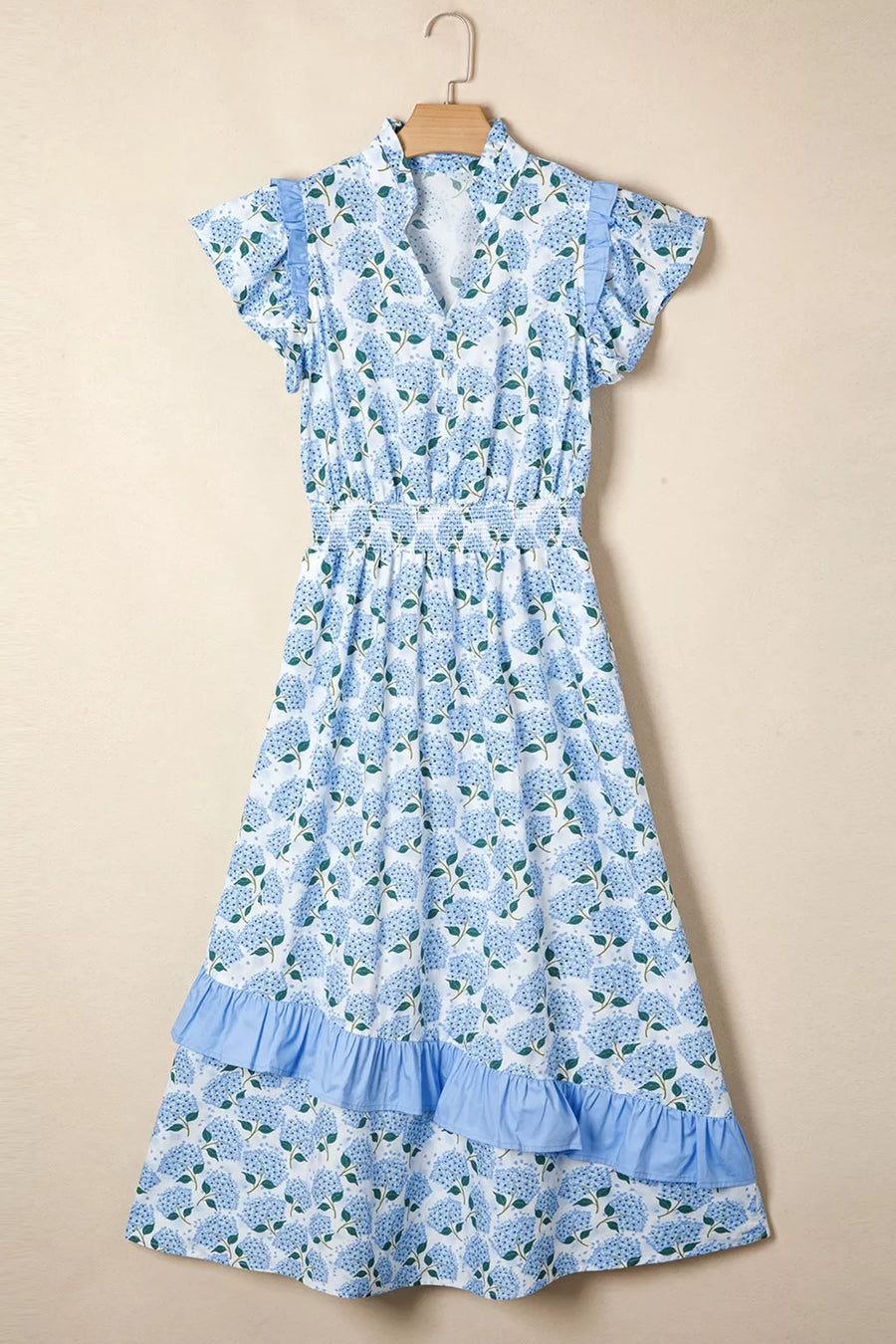 Blue floral dress on a beige background