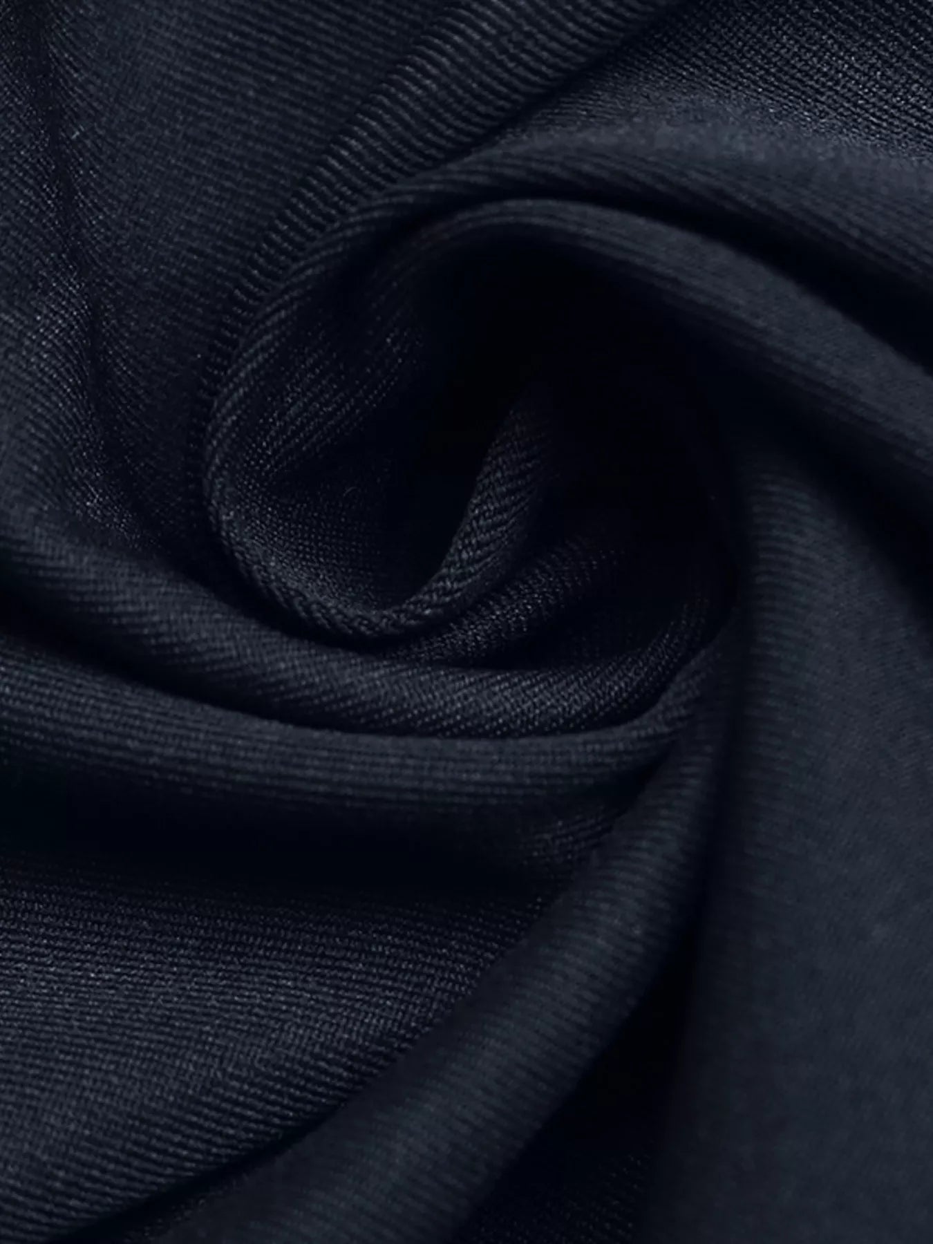 Close-up of dark blue fabric with a subtle pattern