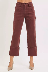 Maroon pants worn by a person on a white background