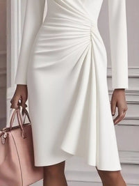 White dress with a pink handbag held by a person