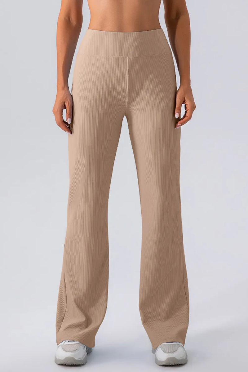 Beige ribbed pants worn by a person on a white background