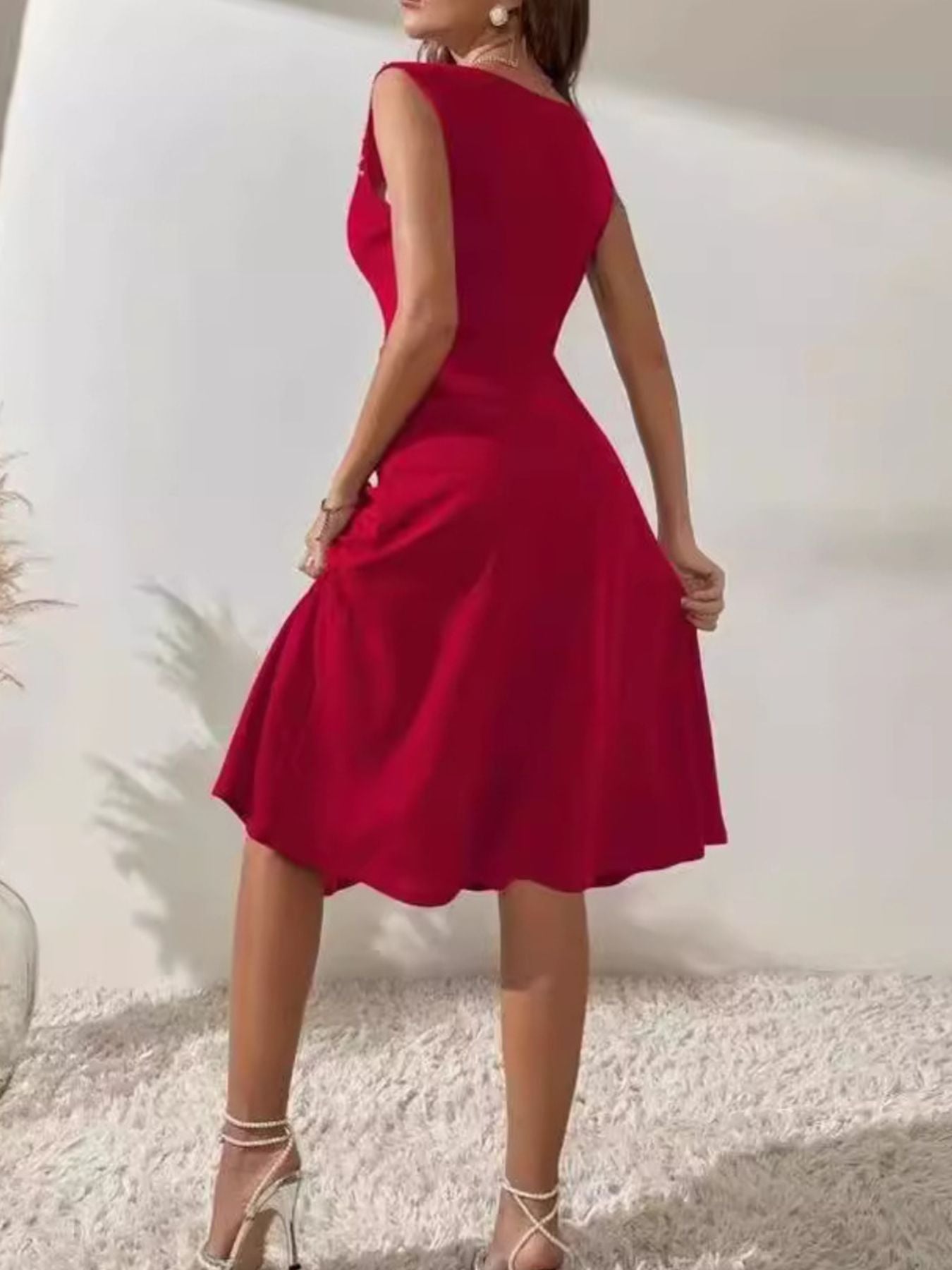 Red dress worn by a person against a white background