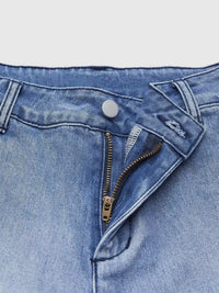 Close-up of a blue denim zipper fly on a white background