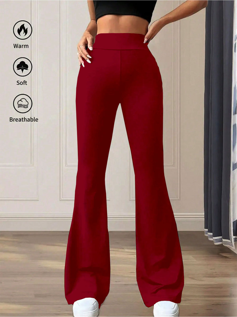 Red flared pants worn by a person with text icons indicating warmth, softness, and breathability on a neutral background.