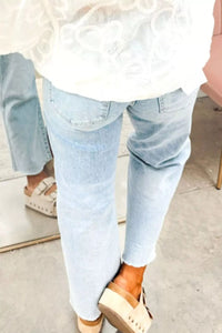Light blue jeans worn by a person with a blurred background