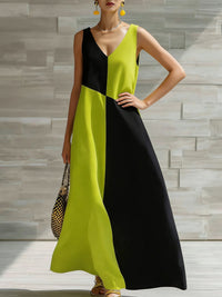 Woman wearing a black and yellow dress against a stone wall background