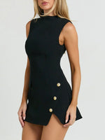 Black dress with gold buttons worn by a model on a white background