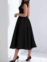 Black dress worn by a person on a white background