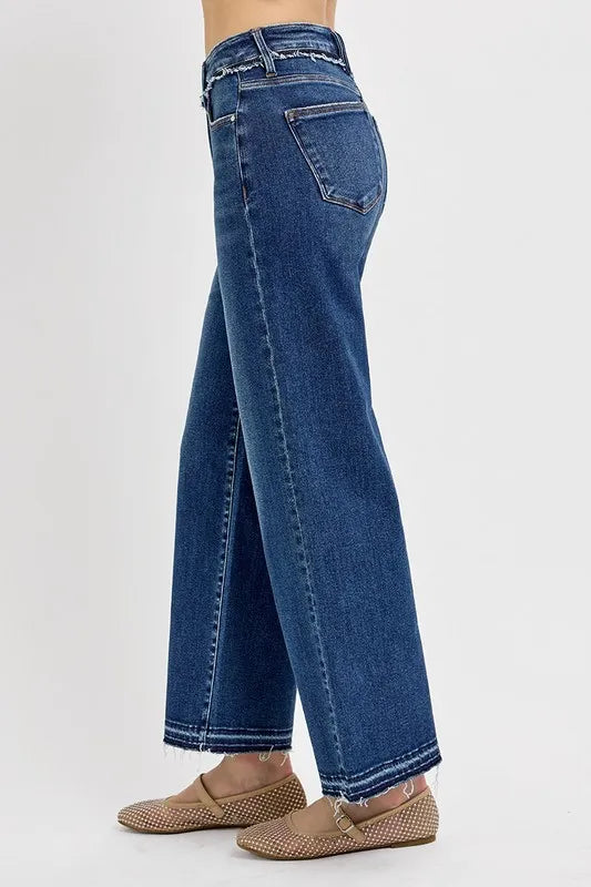 Blue jeans worn by a person on a white background