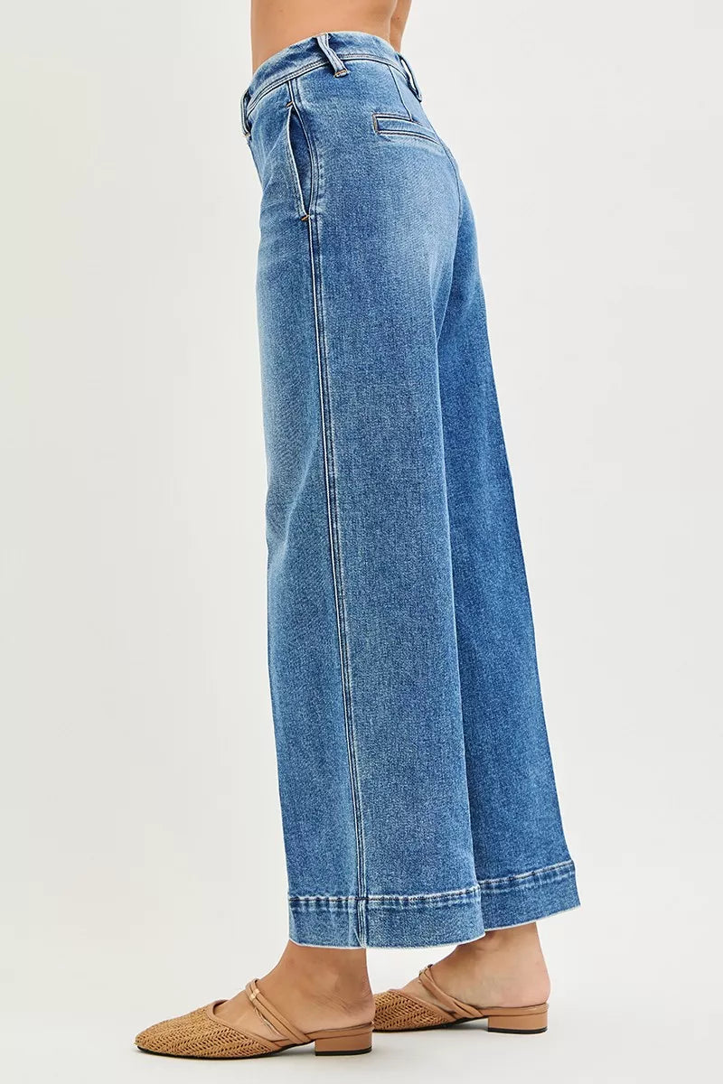 Blue jeans worn by a person on a white background
