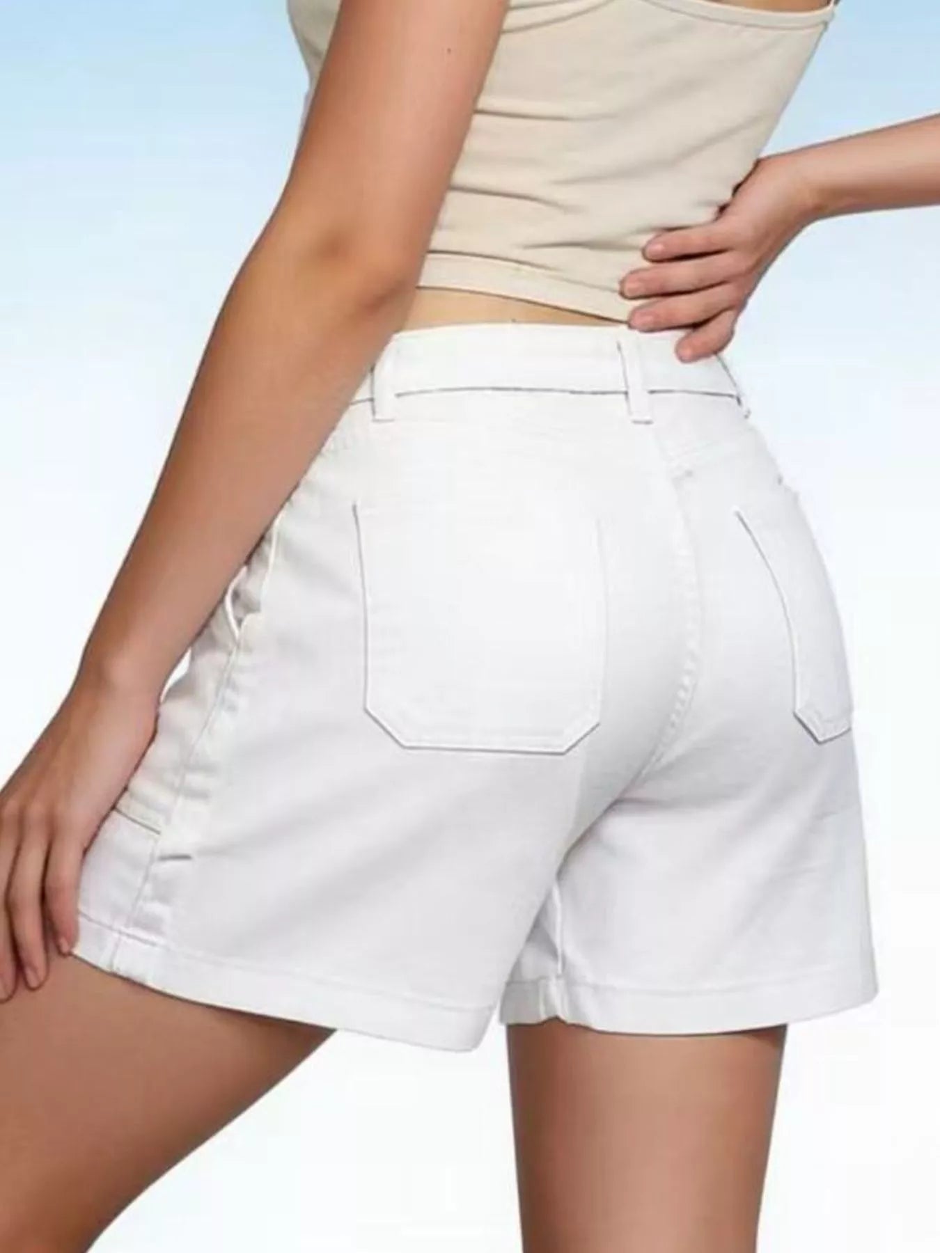 White shorts worn by a person on a light blue background