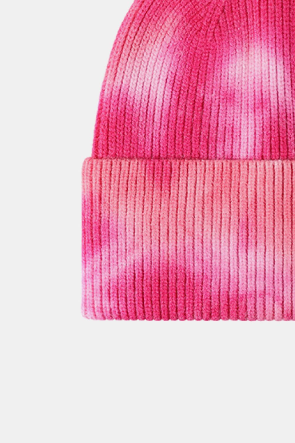 Close-up of a pink knit beanie with a gradient effect on a white background
