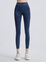 Blue jeans worn by a person on a white background