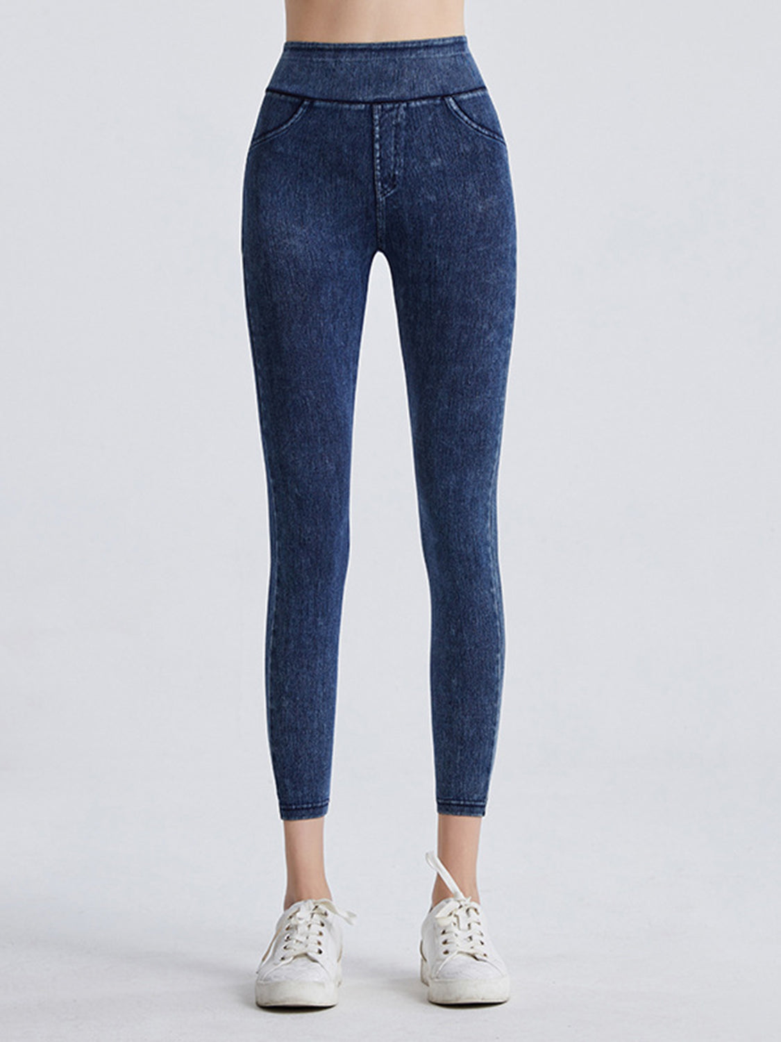 Blue jeans worn by a person on a white background