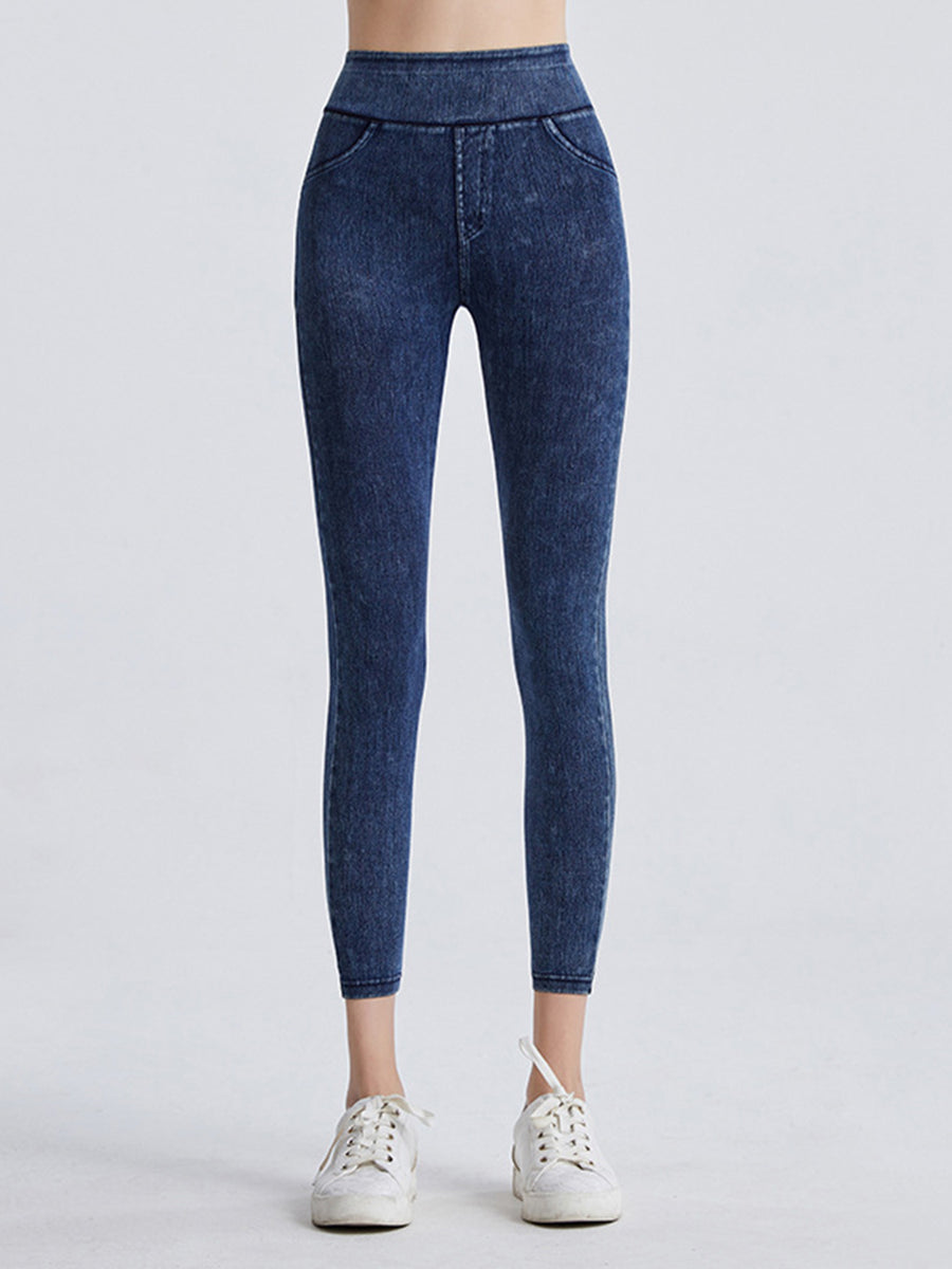 Blue jeans worn by a person on a white background