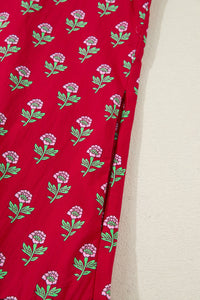 Red fabric with floral pattern on a beige background