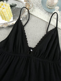 Black lace-trimmed nightgown on a textured surface with decorative elements.