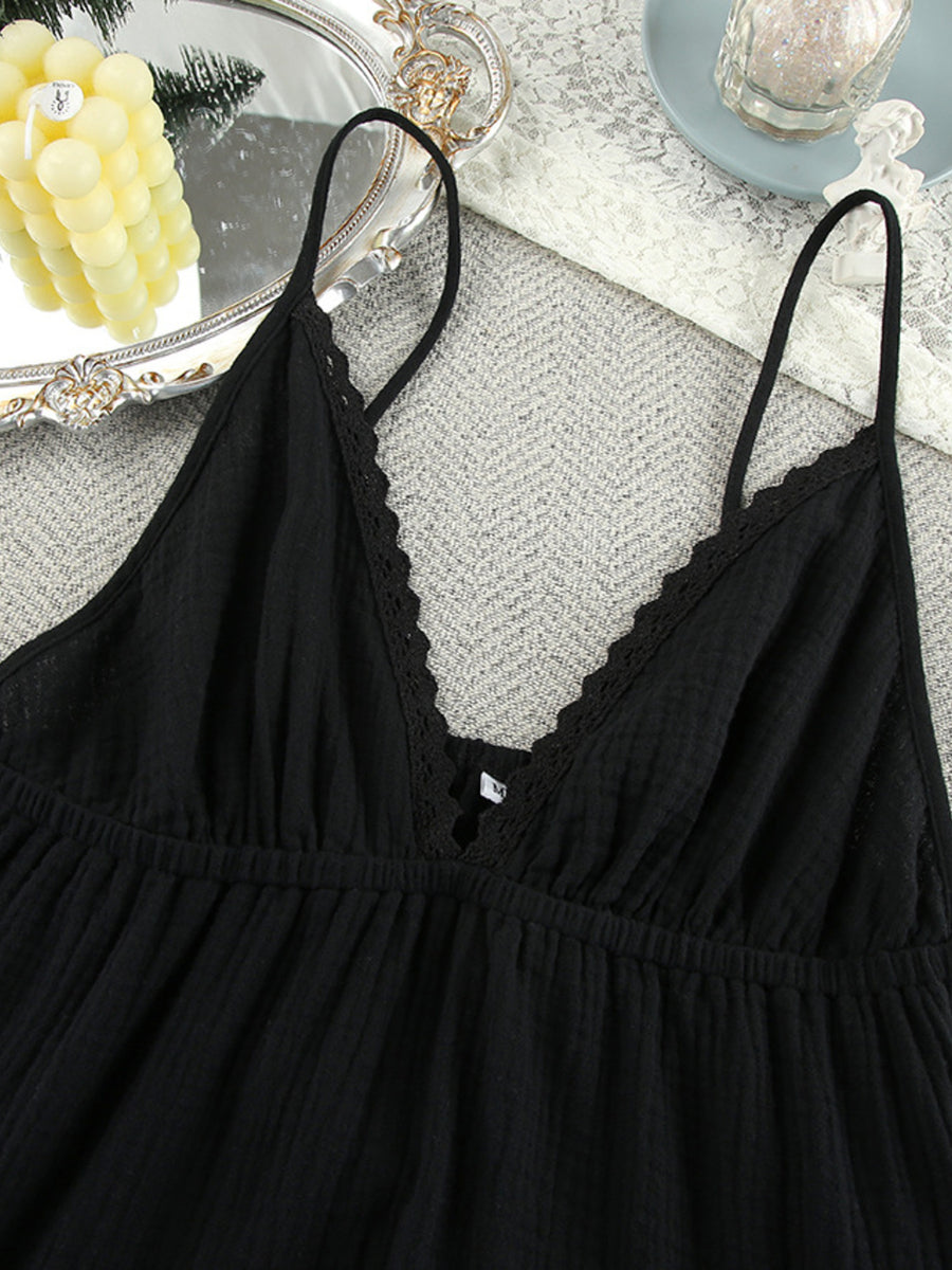Black lace-trimmed nightgown on a textured surface with decorative elements.
