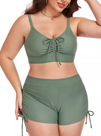 Woman wearing a green bikini set with a white background