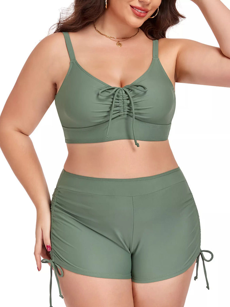 Woman wearing a green bikini set with a white background