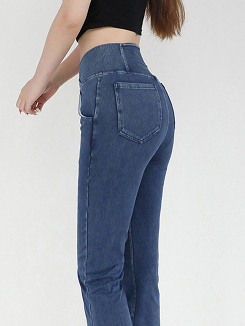 Blue jeans worn by a person on a white background