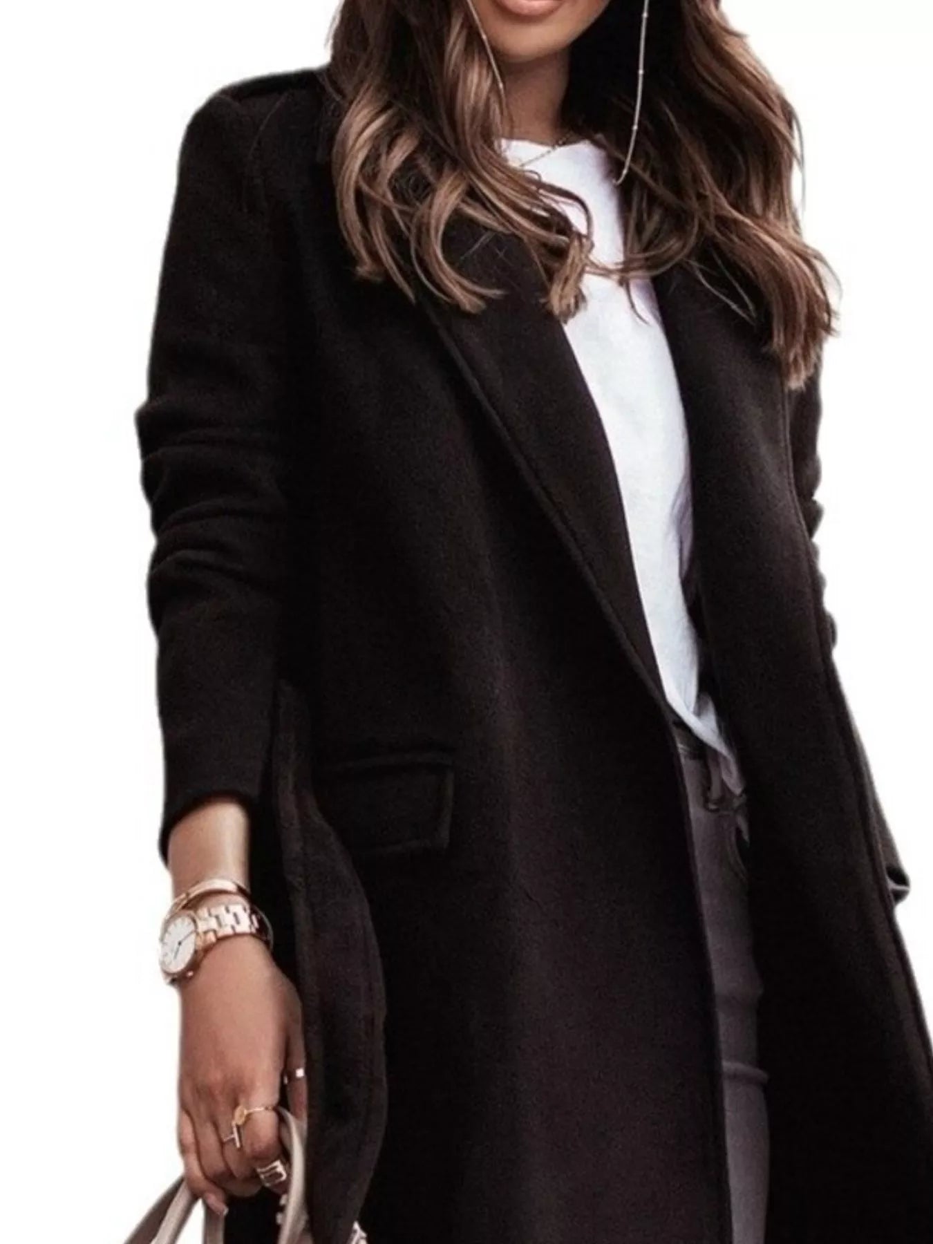 Person wearing a black coat over a white shirt on a plain background