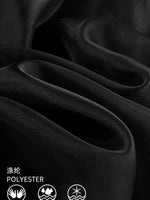 Close-up of black fabric with polyester label and icons.