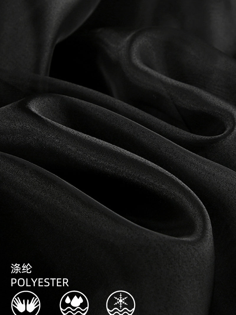 Close-up of black fabric with polyester label and icons.