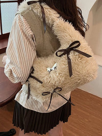 Person wearing a fluffy beige backpack with brown ribbons indoors.