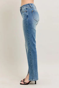 Blue jeans worn by a person on a plain background