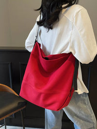 Person wearing a red bag over one shoulder indoors.