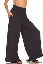 Black wide-leg pants worn by a person on a white background