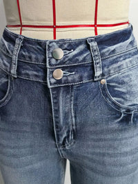 Close-up of blue jeans with a checkered shirt in the background