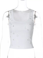 White tank top with pearl embellishments on a mannequin against a white background