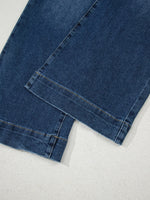 Close-up of blue denim fabric on a white background